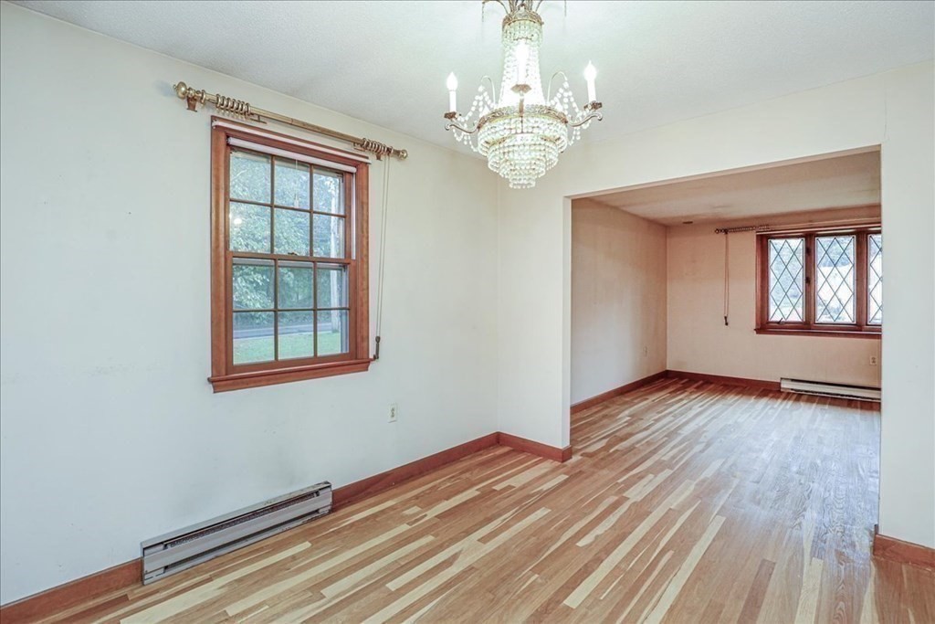 1 Donald Circle Andover, MA 01810 - Photo 13 of 42 a view of an empty room with wooden floor and a window