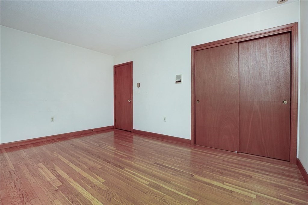 1 Donald Circle Andover, MA 01810 - Photo 15 of 42 an empty room with wooden floor and closet area