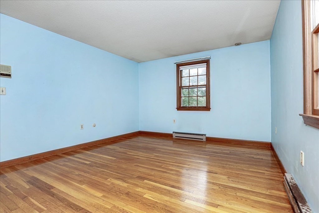 1 Donald Circle Andover, MA 01810 - Photo 17 of 42 a view of an empty room with wooden floor and a window