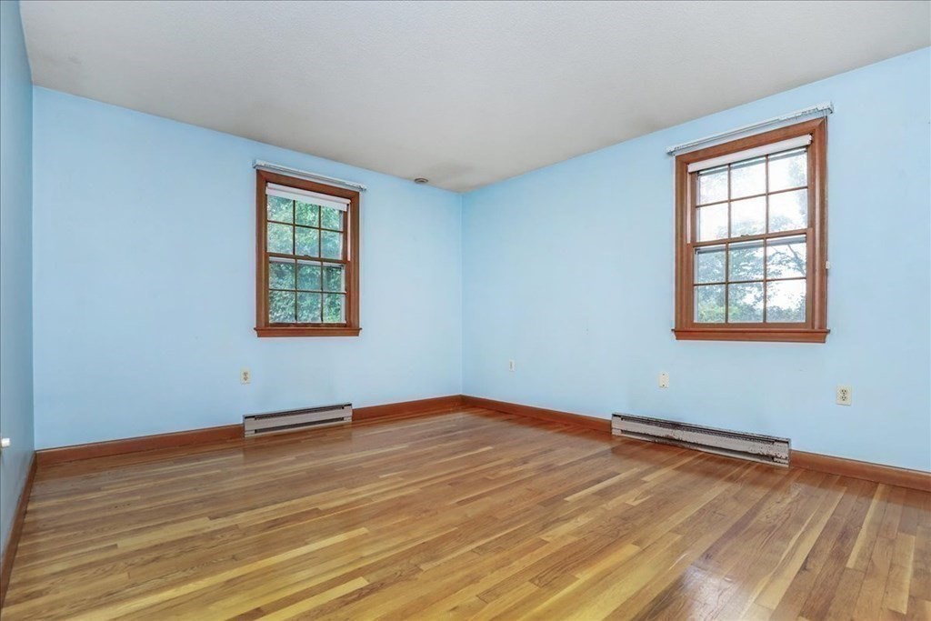 1 Donald Circle Andover, MA 01810 - Photo 18 of 42 an empty room with wooden floor and windows