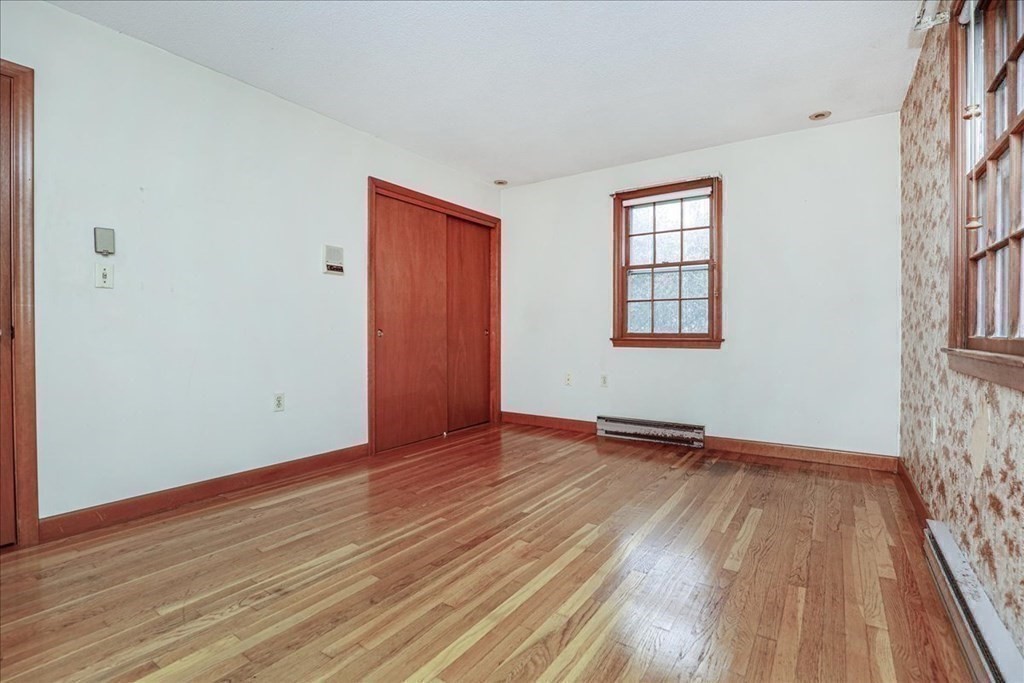 1 Donald Circle Andover, MA 01810 - Photo 20 of 42 a view of an empty room with wooden floor and a window