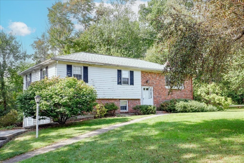 1 Donald Circle Andover, MA 01810 - Photo 2 of 42 a front view of a house with a yard and trees