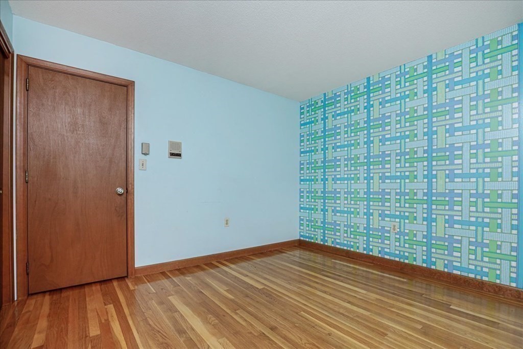 1 Donald Circle Andover, MA 01810 - Photo 22 of 42 a view of empty room with wooden floor and fan