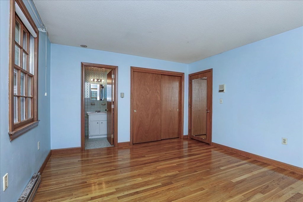 1 Donald Circle Andover, MA 01810 - Photo 24 of 42 a view of an empty room with wooden floor and a window