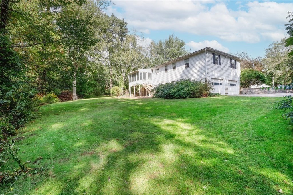 1 Donald Circle Andover, MA 01810 - Photo 27 of 42 a front view of a house with a yard and garage
