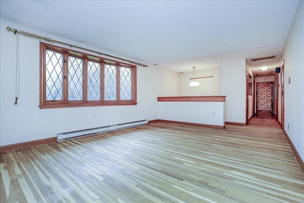 1 Donald Circle Andover, MA 01810 - Photo 3 of 42 a view of empty room with wooden floor and fan