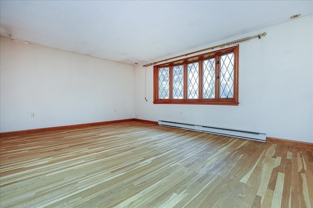 1 Donald Circle Andover, MA 01810 - Photo 4 of 42 a view of an empty room with wooden floor and a window
