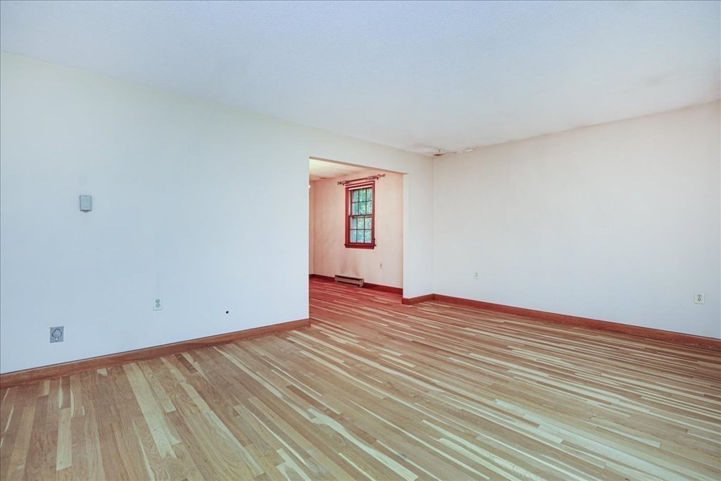 1 Donald Circle Andover, MA 01810 - Photo 5 of 42 a view of an empty room with wooden floor and a window