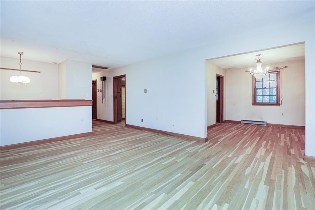 1 Donald Circle Andover, MA 01810 - Photo 6 of 42 an empty room with wooden floor and windows