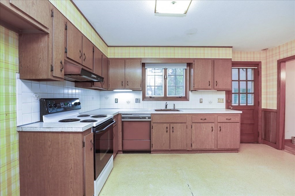 1 Donald Circle Andover, MA 01810 - Photo 7 of 42 a kitchen with stainless steel appliances granite countertop a sink stove and cabinets