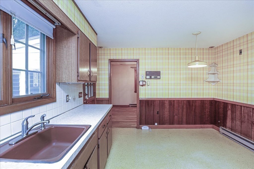 1 Donald Circle Andover, MA 01810 - Photo 10 of 42 a kitchen with a sink cabinets and wooden floor
