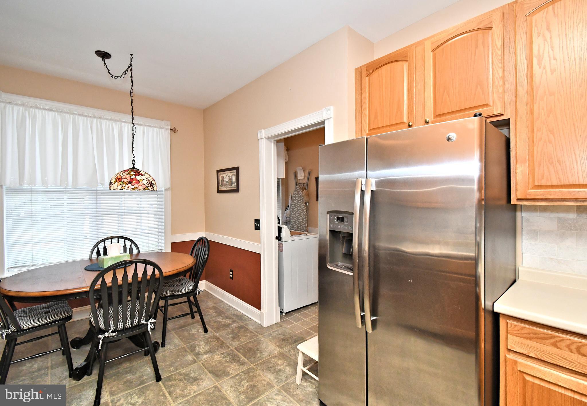 2 Newbury Way Lansdale, PA 19446 - Photo 13 of 29 a kitchen with a refrigerator a table and chairs