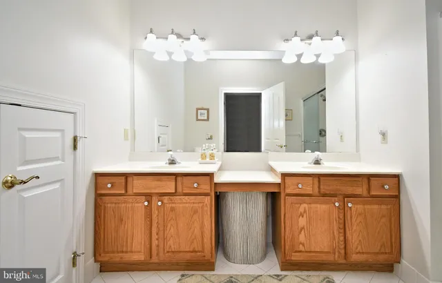 a bathroom with a sink double vanity and a mirror