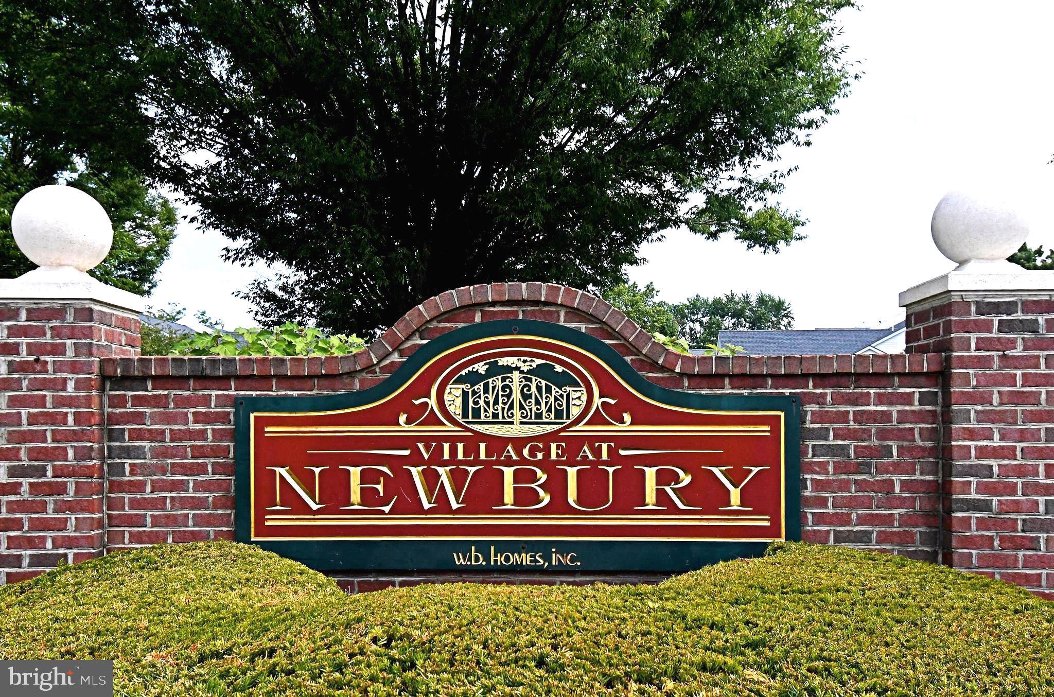 2 Newbury Way Lansdale, PA 19446 - Photo 2 of 29 a sign that is on a brick wall