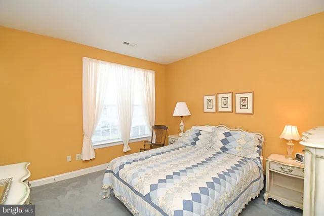 a bedroom with a bed and a lamp