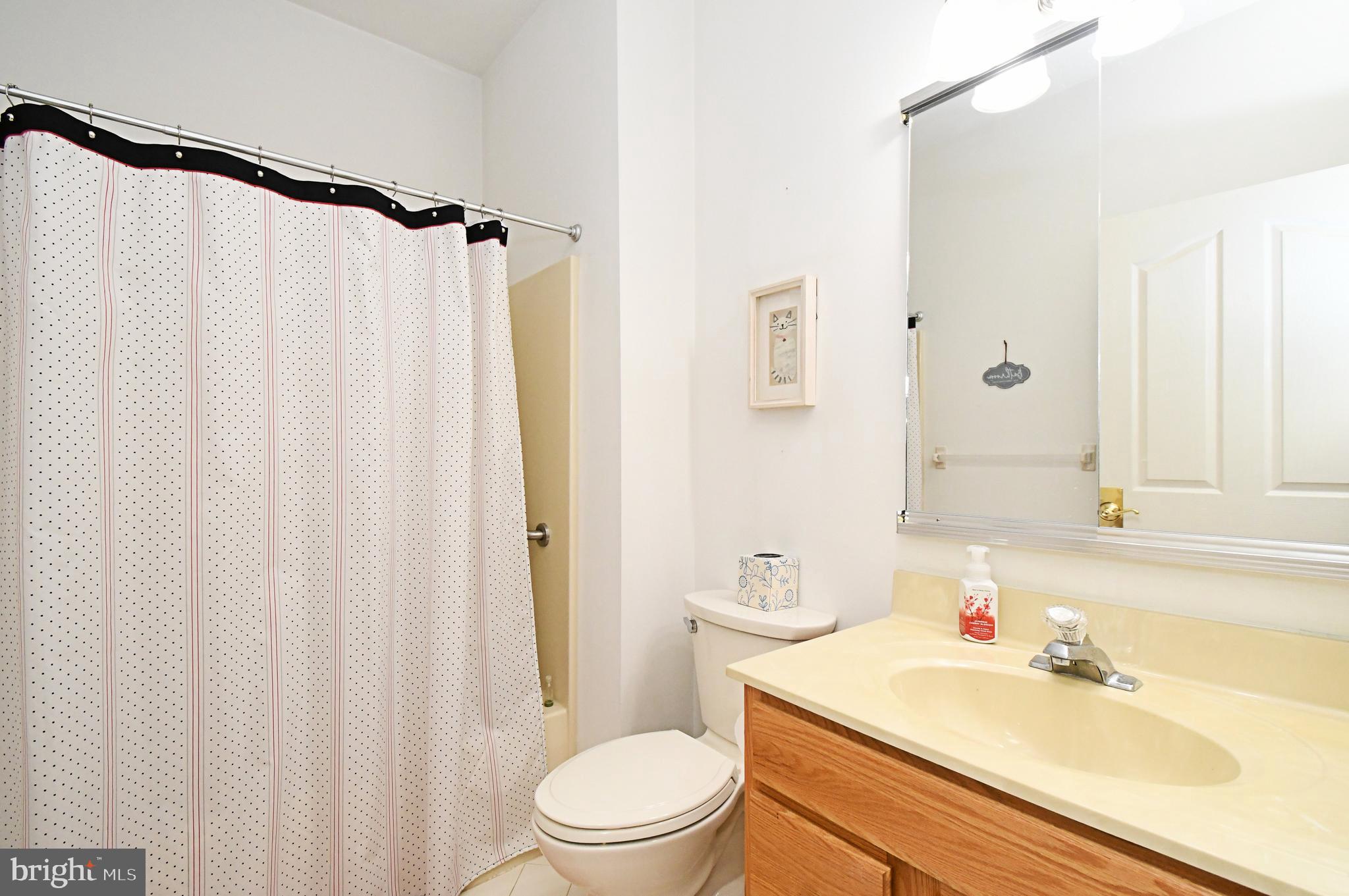 2 Newbury Way Lansdale, PA 19446 - Photo 23 of 29 a bathroom with a sink a toilet and shower curtain