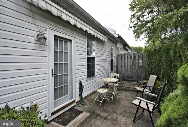 a view of a patio with table and chairs and potted plants with sky view