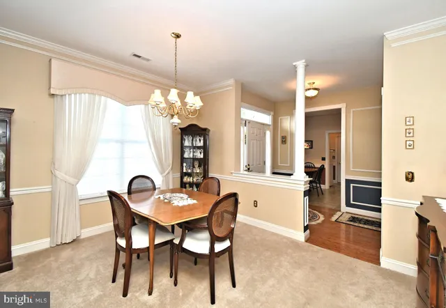 a dining room with furniture and window
