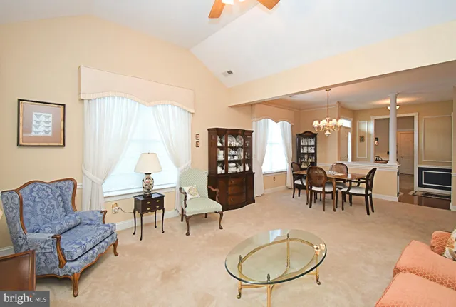 a living room with furniture kitchen and a table