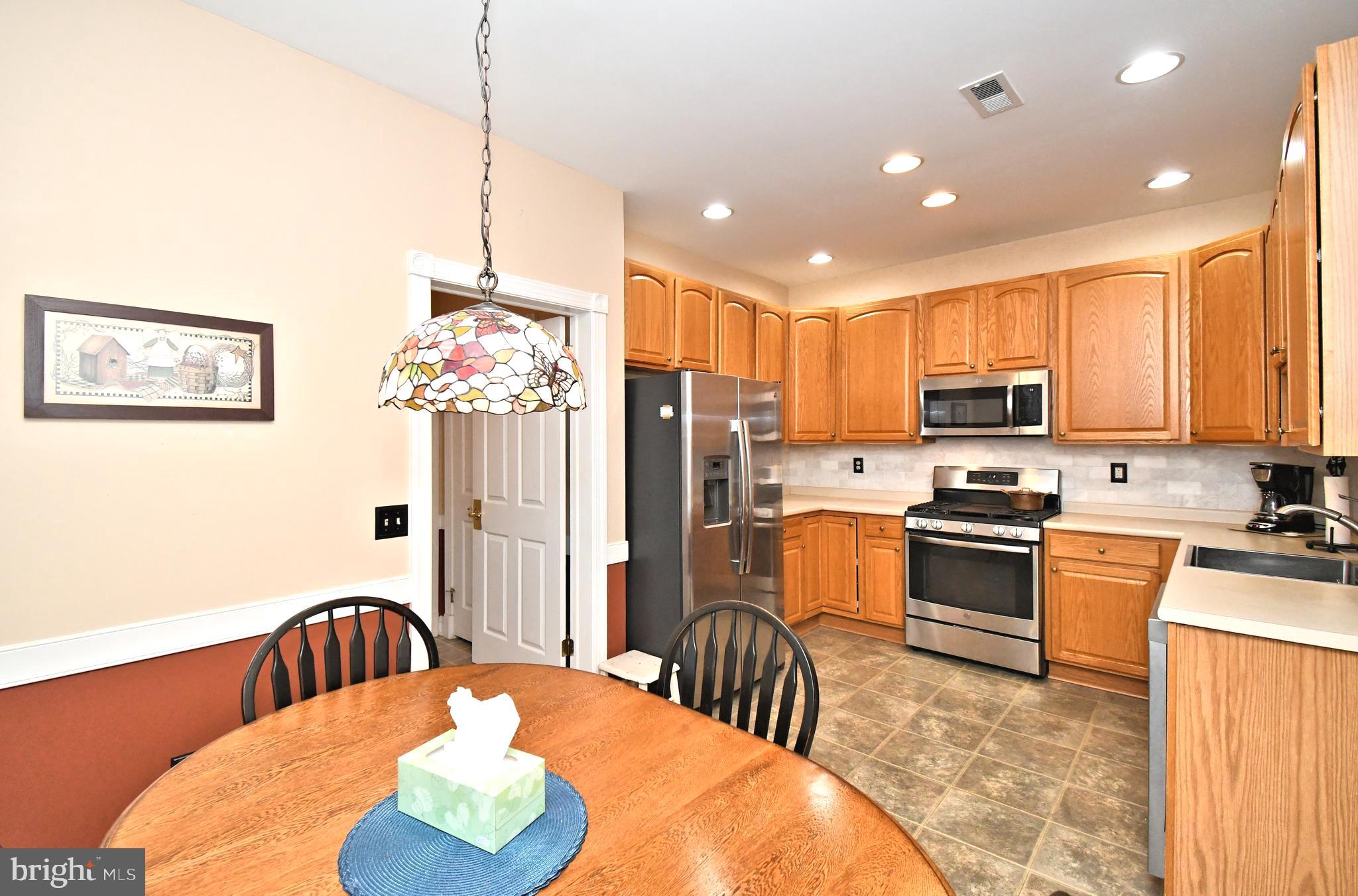 2 Newbury Way Lansdale, PA 19446 - Photo 10 of 29 a kitchen with stainless steel appliances granite countertop a refrigerator a stove top oven a sink dishwasher and wooden cabinets