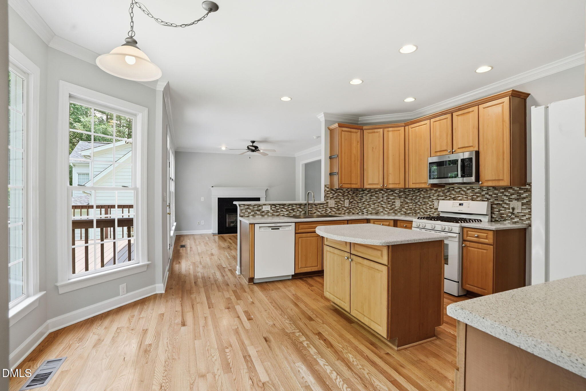 7 Morgans Ridge Lane Durham, NC 27707 - Photo 23 of 75 a kitchen with granite countertop a stove top oven a sink dishwasher a dining table and chairs with wooden floor