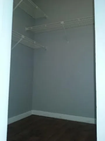 a empty closet with wooden floor