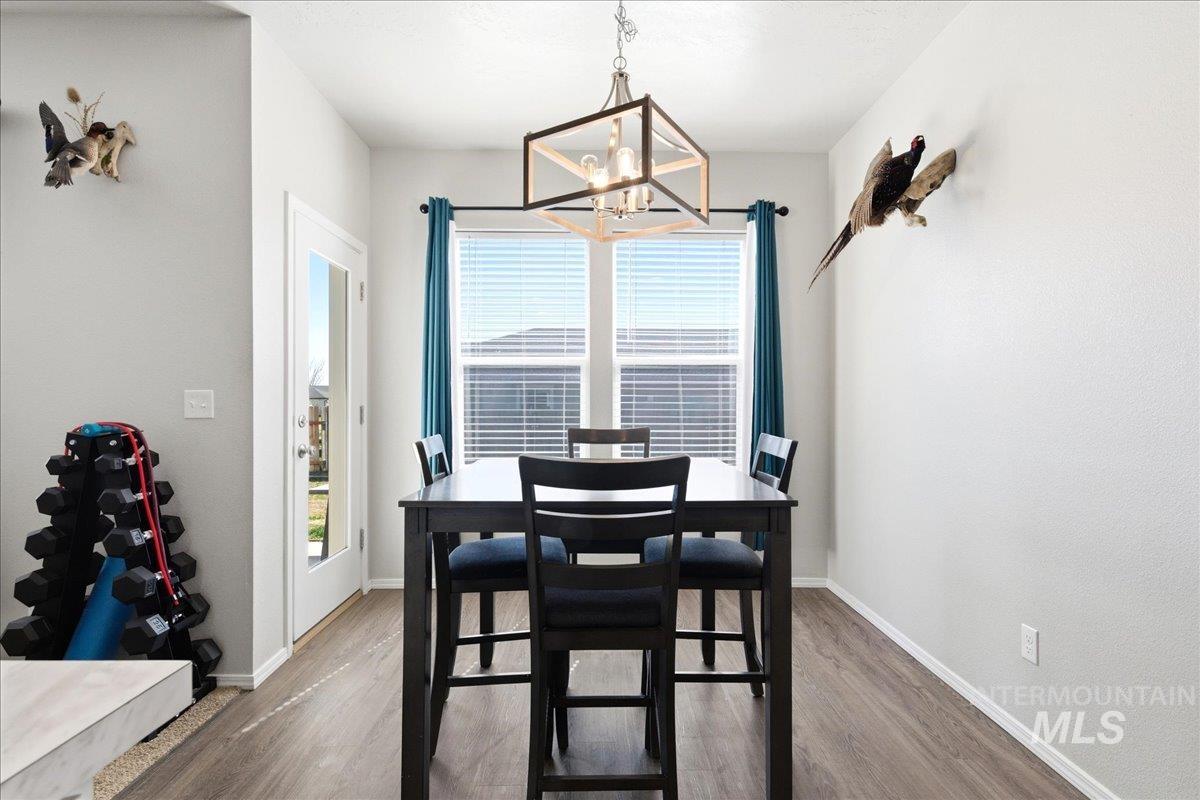 843 Southwest Levant Way Mountain Home, ID 83647 - Photo 12 of 45 Dining area with wood finished floors and hanging lights