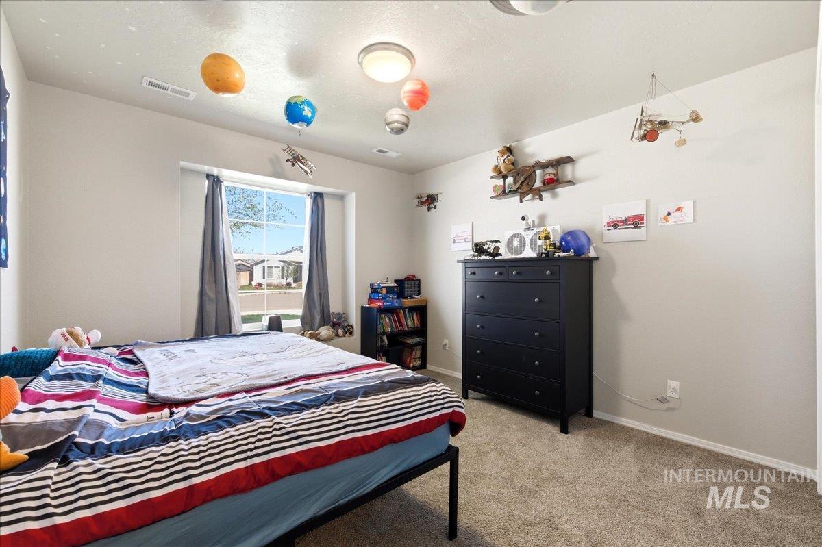 843 Southwest Levant Way Mountain Home, ID 83647 - Photo 17 of 45 Bedroom with baseboards and light carpet
