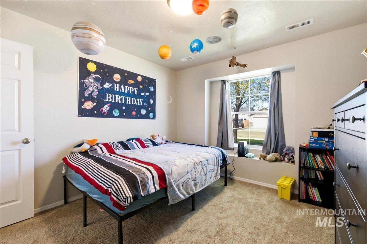 843 Southwest Levant Way Mountain Home, ID 83647 - Photo 18 of 45 Bedroom with baseboards and light colored carpet