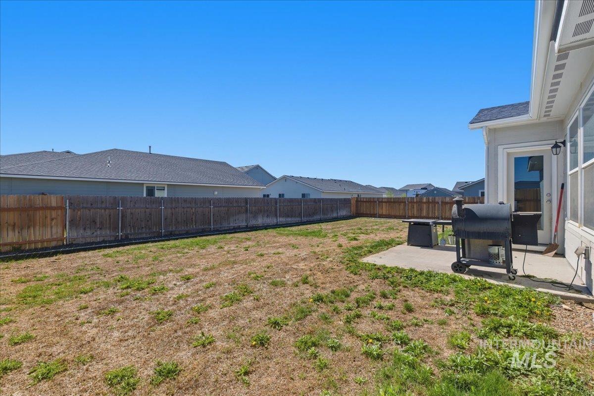 843 Southwest Levant Way Mountain Home, ID 83647 - Photo 25 of 45 Fenced backyard with a patio area and a residential view