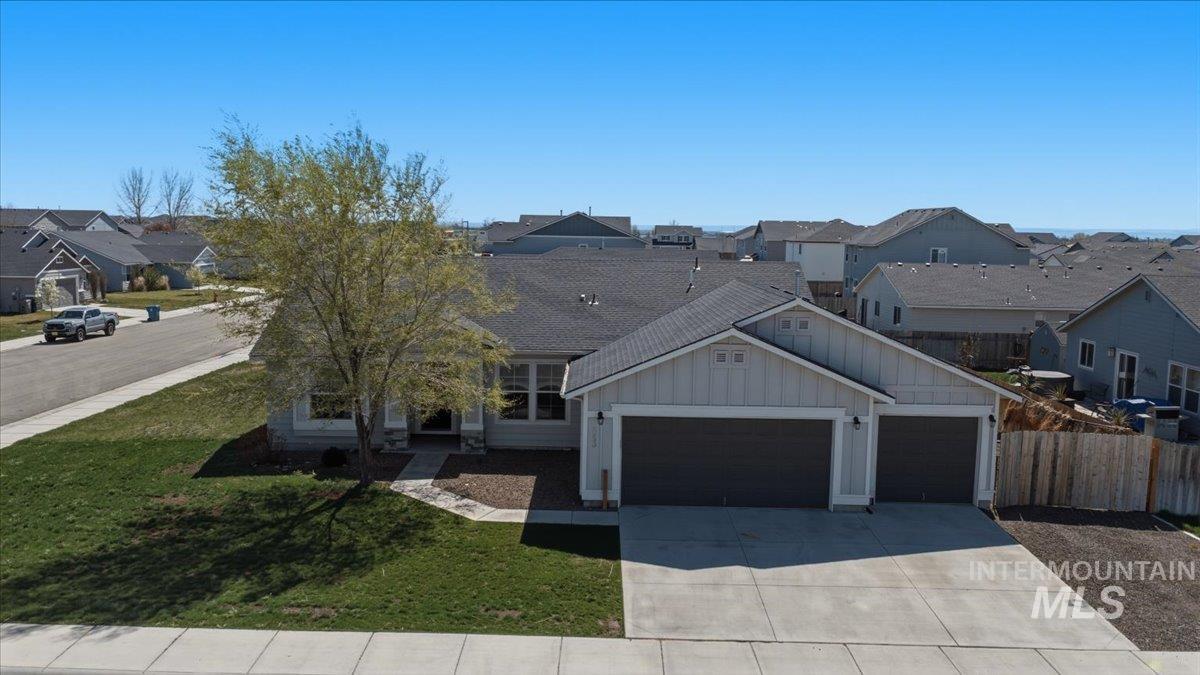 843 Southwest Levant Way Mountain Home, ID 83647 - Photo 28 of 45 View of front of property featuring board and batten siding, a residential view, a garage, and concrete driveway
