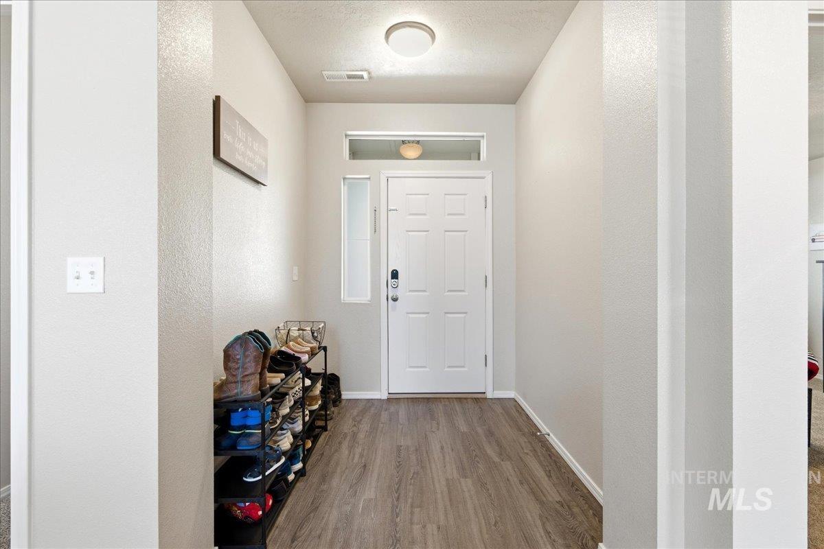 843 Southwest Levant Way Mountain Home, ID 83647 - Photo 3 of 45 Entryway with wood finished floors and a textured ceiling