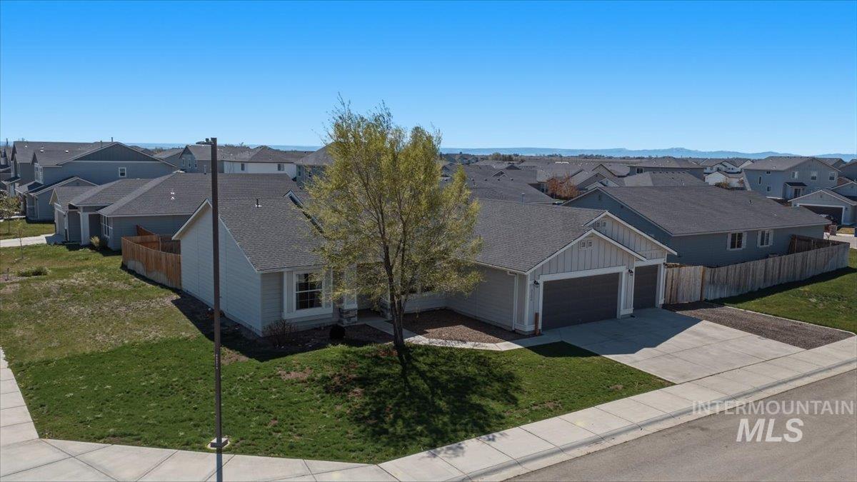 843 Southwest Levant Way Mountain Home, ID 83647 - Photo 29 of 45 View of front of home featuring a residential view, an attached garage, concrete driveway, roof with shingles, and board and batten siding