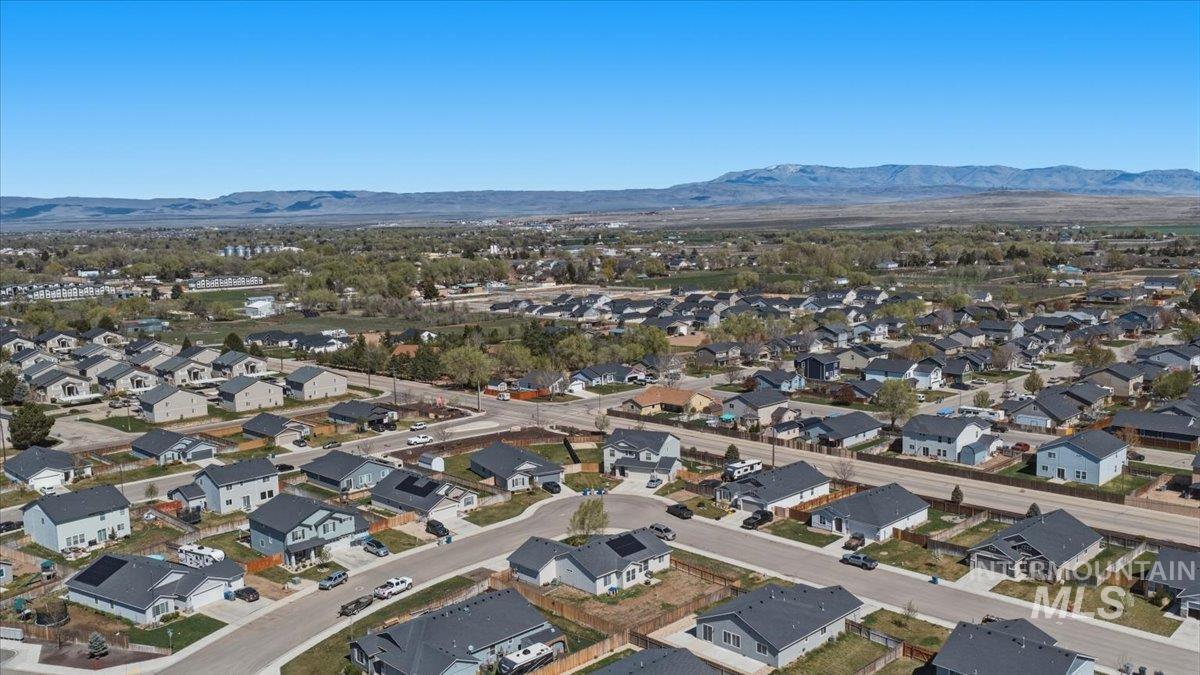 843 Southwest Levant Way Mountain Home, ID 83647 - Photo 33 of 45 Aerial perspective of suburban area featuring a mountain backdrop