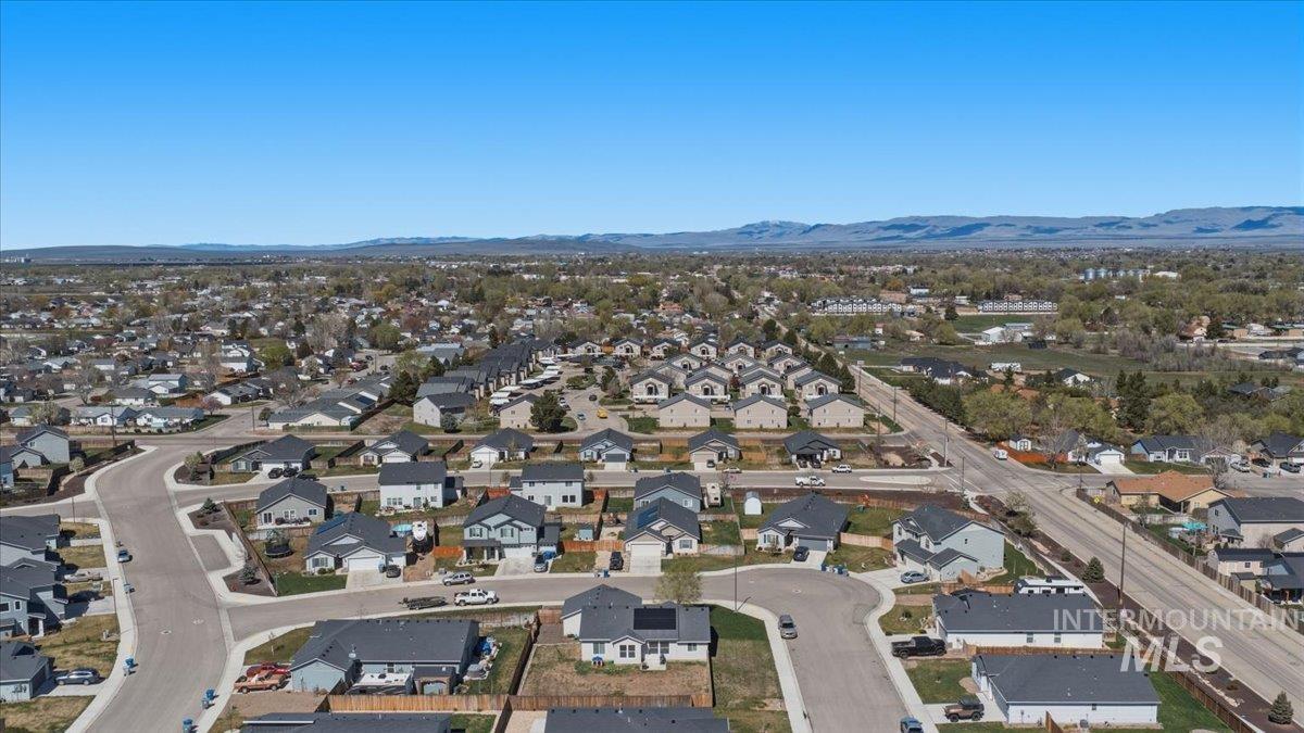 843 Southwest Levant Way Mountain Home, ID 83647 - Photo 34 of 45 Aerial view of residential area featuring a mountainous background