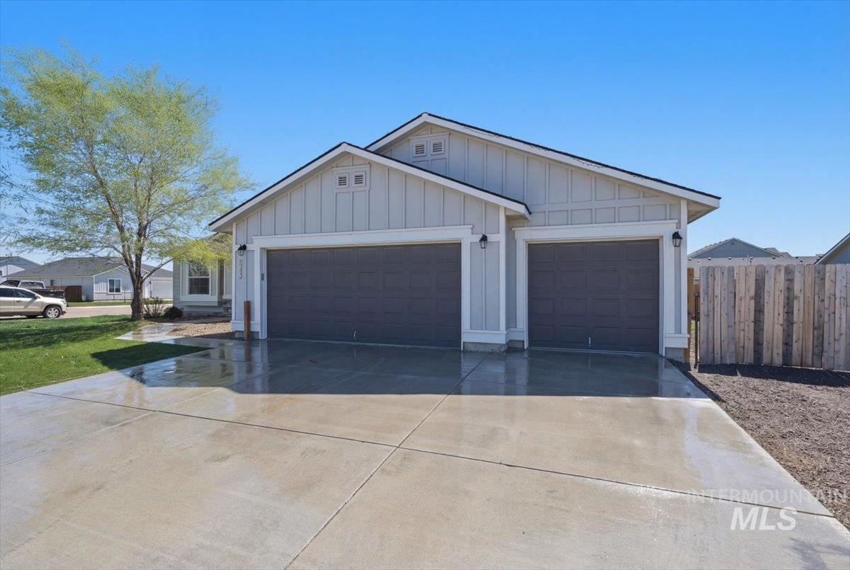 843 Southwest Levant Way Mountain Home, ID 83647 - Photo 41 of 45 View of front of house with board and batten siding, driveway, and an attached garage