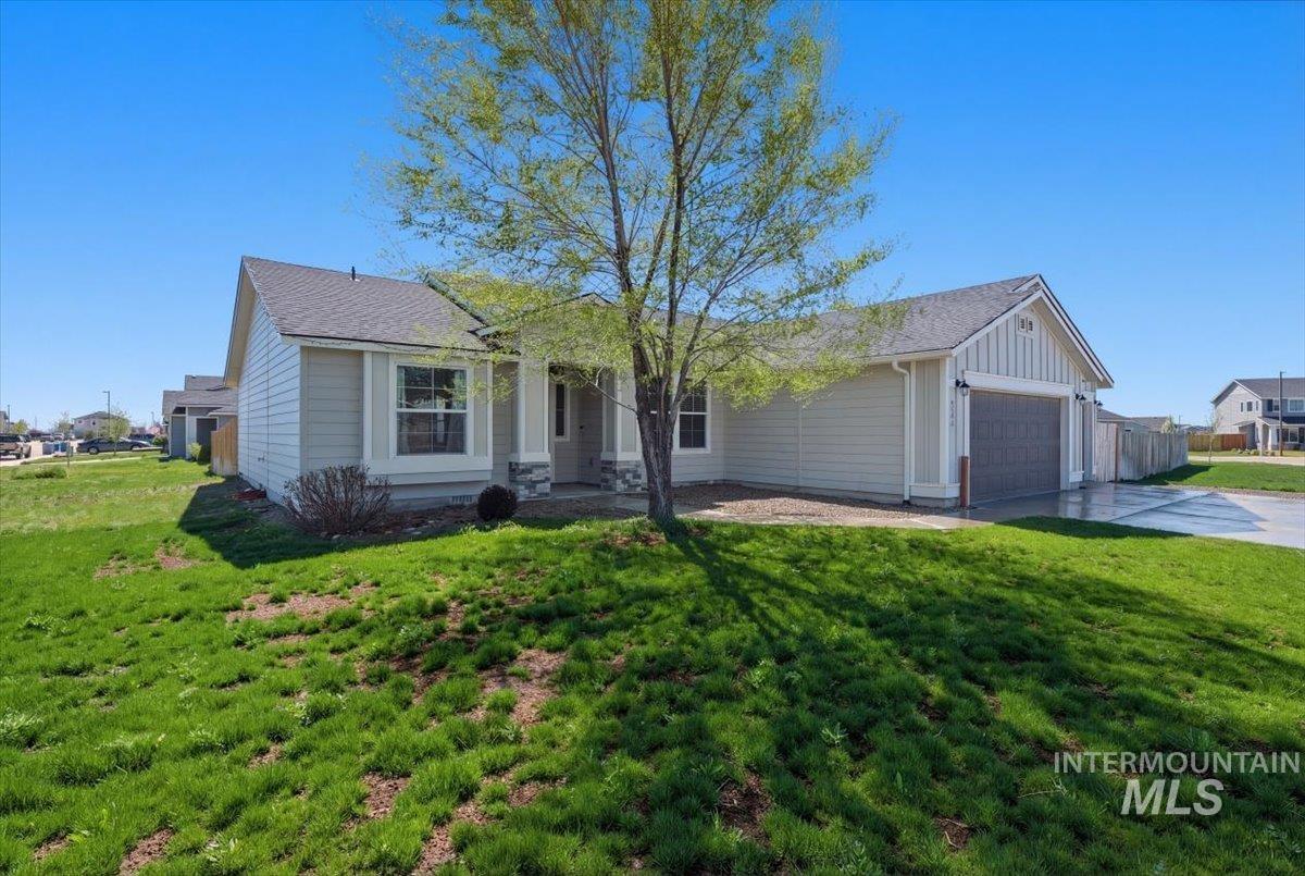 843 Southwest Levant Way Mountain Home, ID 83647 - Photo 42 of 45 View of front of house featuring a garage, a front lawn, driveway, and board and batten siding