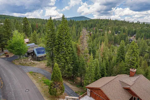 an aerial view of a house with a yard basket ball court and outdoor seating
