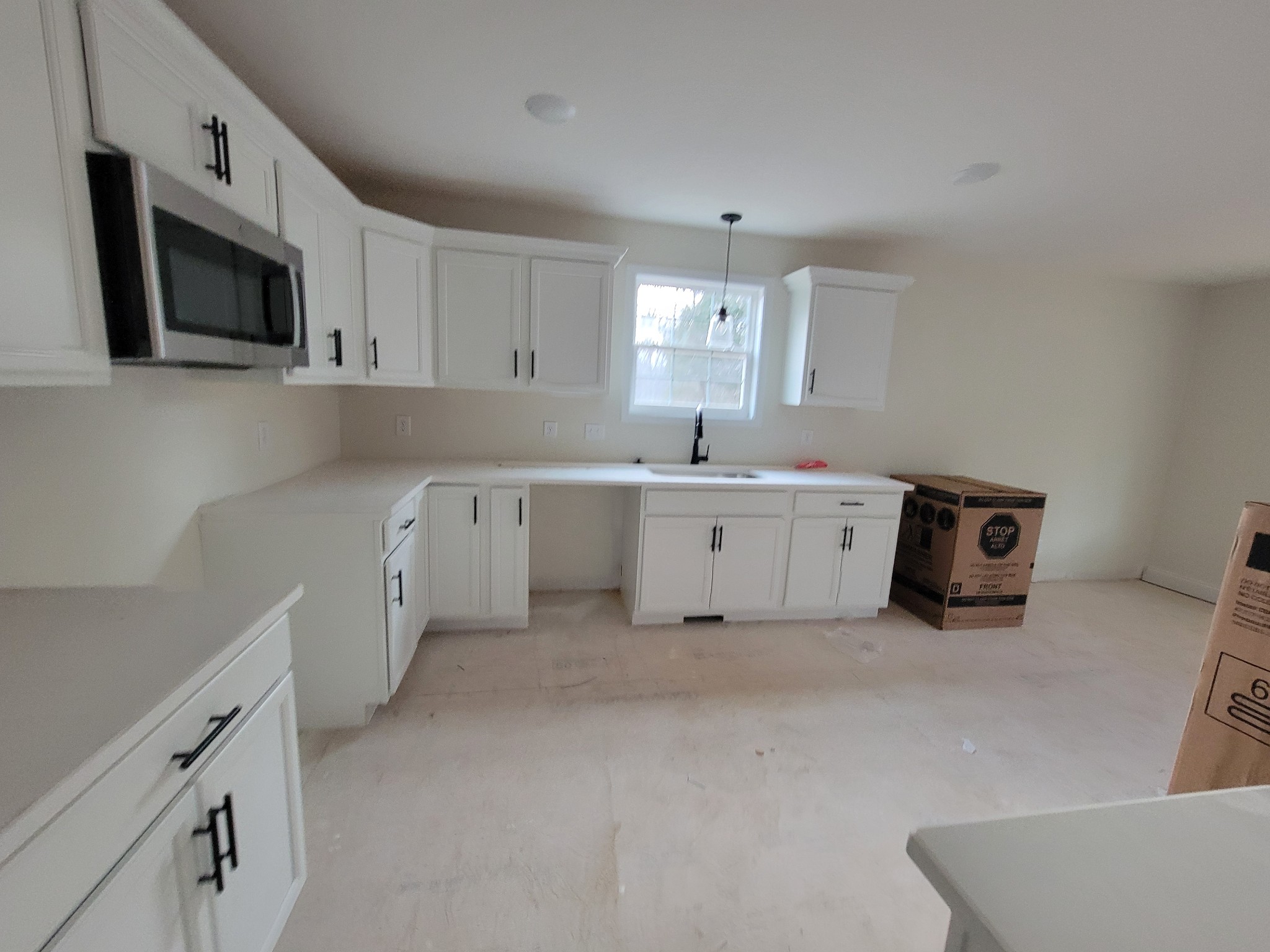 2285 Mockingbird Hill Road Palmyra, TN 37142 - Photo 5 of 19 a large white kitchen with a sink a microwave and cabinets