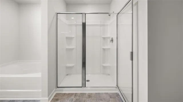 a bathroom with a glass shower door