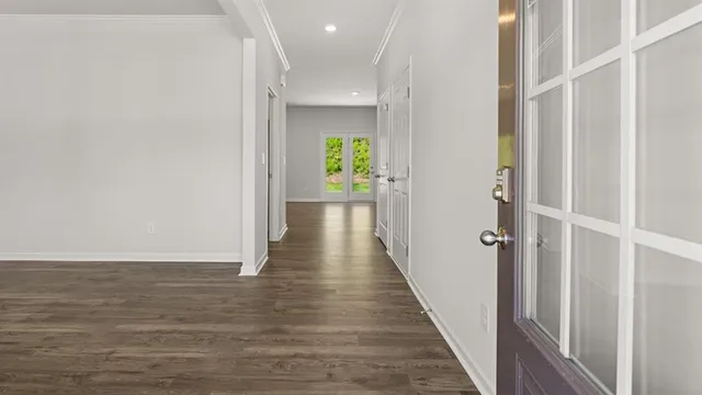 a view of hallway with wooden floor