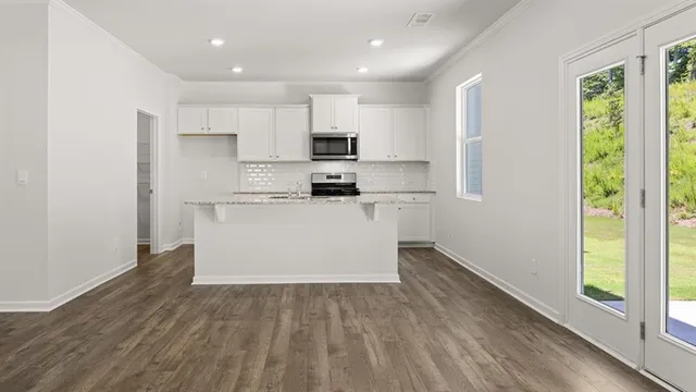 a kitchen with a refrigerator and a stove top oven