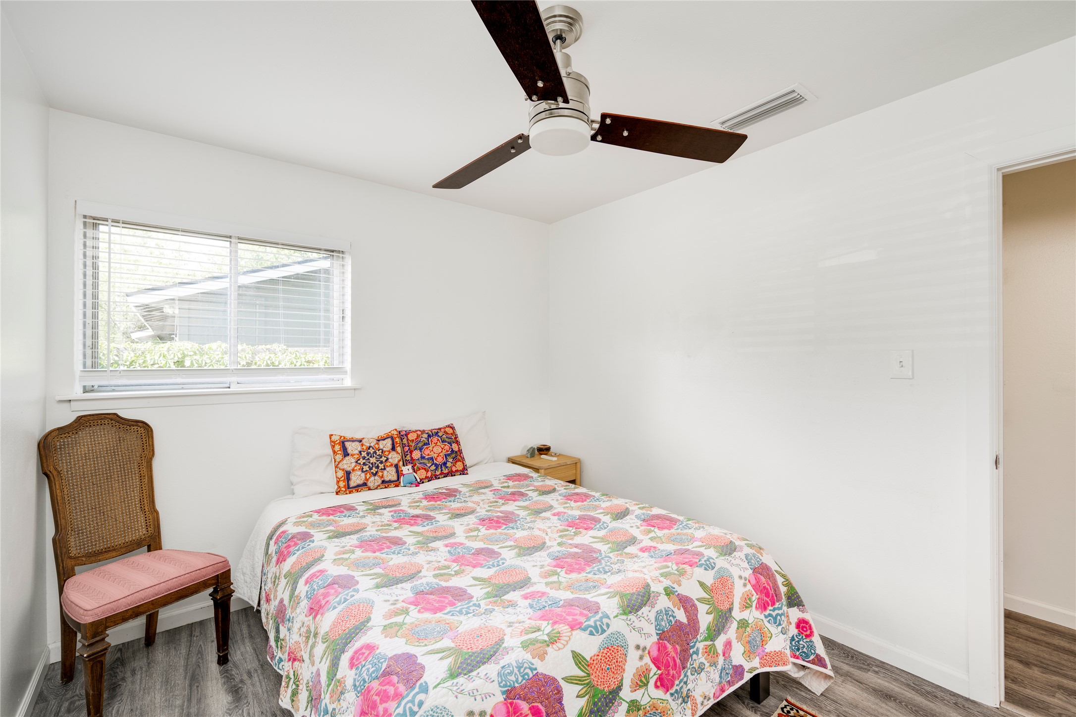 5300 Halmark Drive Austin, TX 78723 - Photo 17 of 40 A well-lit bedroom featuring a functional ceiling fan for optimal air circulation.