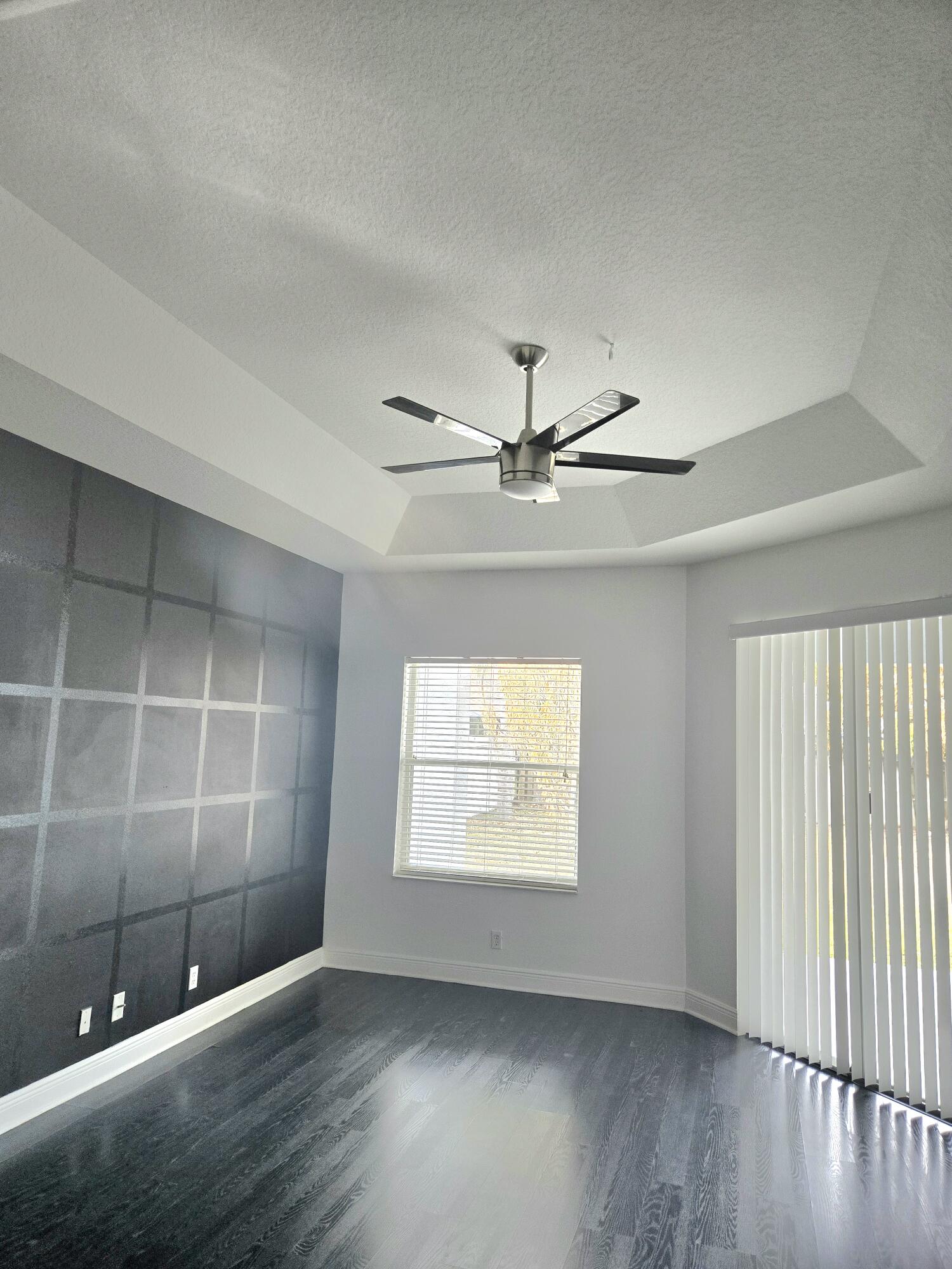 2472 Southwest Valnera Street Port St. Lucie, FL 34953 - Photo 14 of 30 an empty room with wooden floor and windows