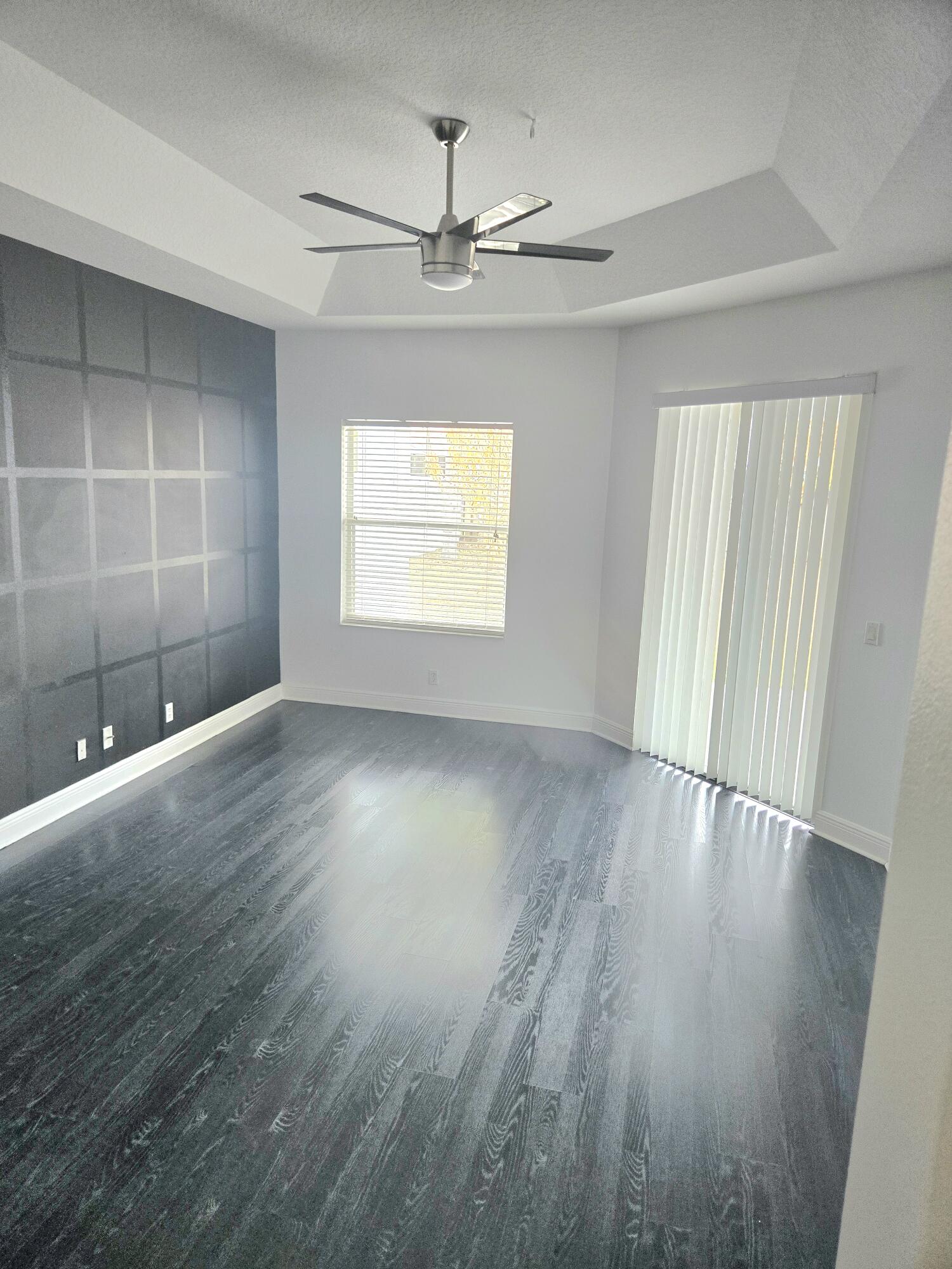 2472 Southwest Valnera Street Port St. Lucie, FL 34953 - Photo 15 of 30 an empty room with wooden floor and windows