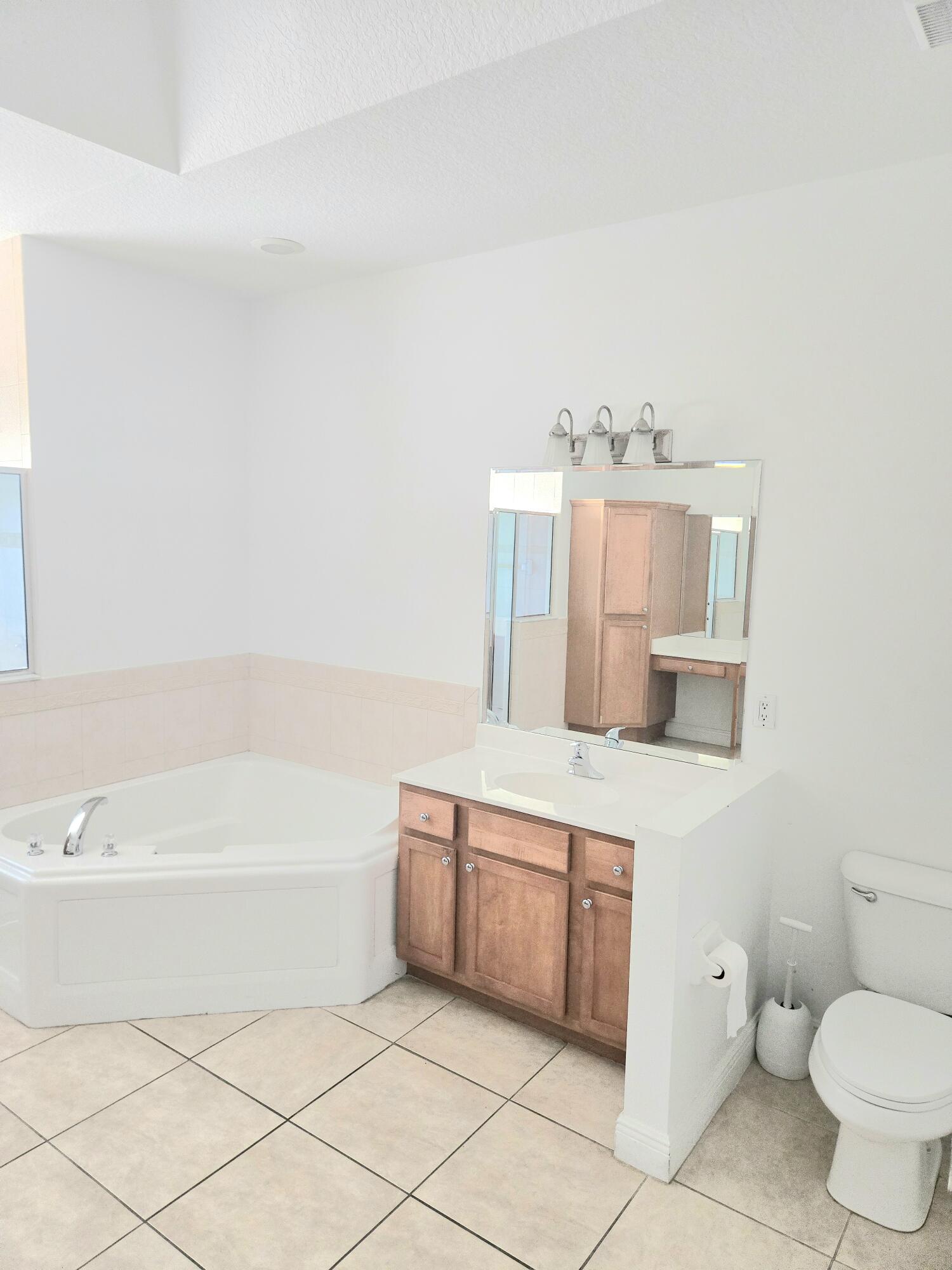 2472 Southwest Valnera Street Port St. Lucie, FL 34953 - Photo 18 of 30 a bathroom with a bathtub sink and toilet