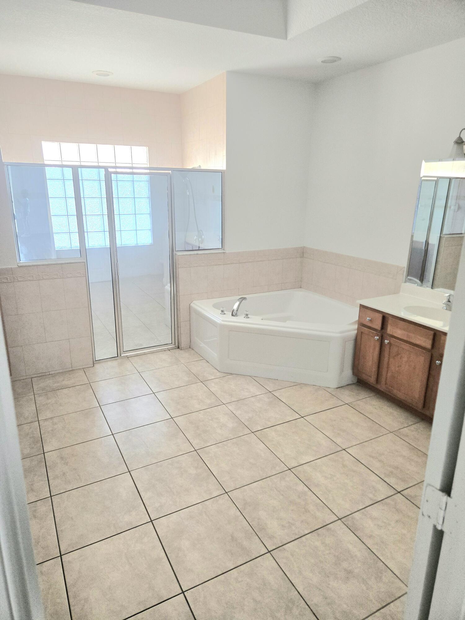 2472 Southwest Valnera Street Port St. Lucie, FL 34953 - Photo 19 of 30 a spacious bathroom with a bathtub and shower