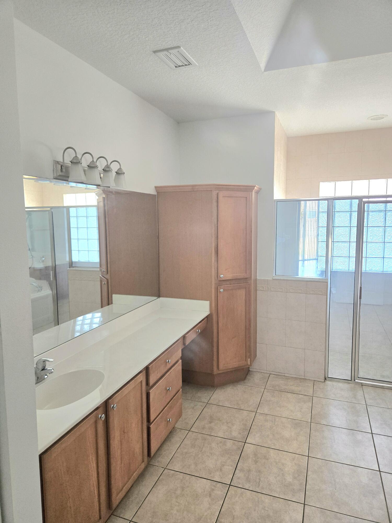 2472 Southwest Valnera Street Port St. Lucie, FL 34953 - Photo 20 of 30 a kitchen with a sink and a refrigerator