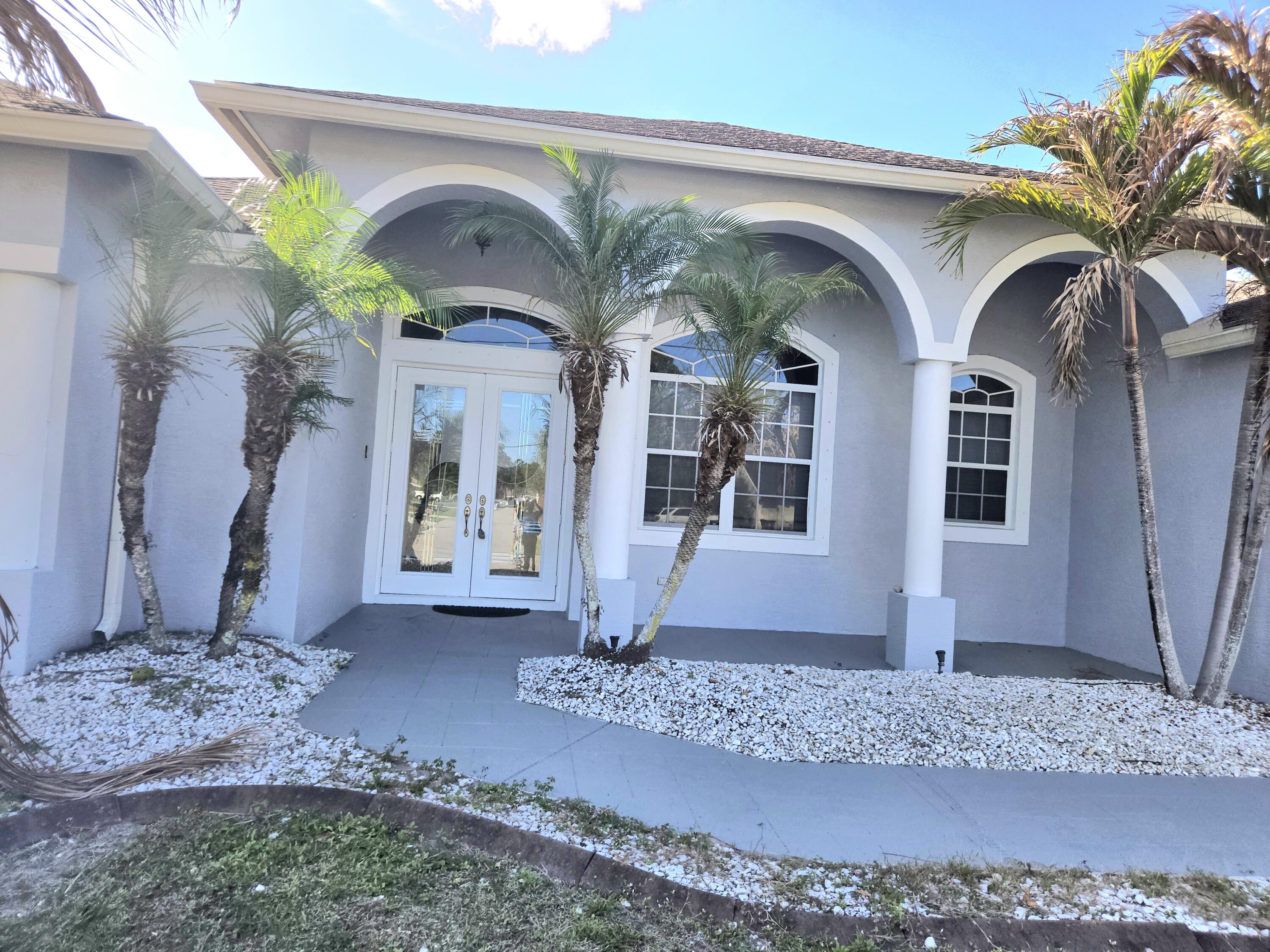 2472 Southwest Valnera Street Port St. Lucie, FL 34953 - Photo 2 of 30 a front view of a house with garden