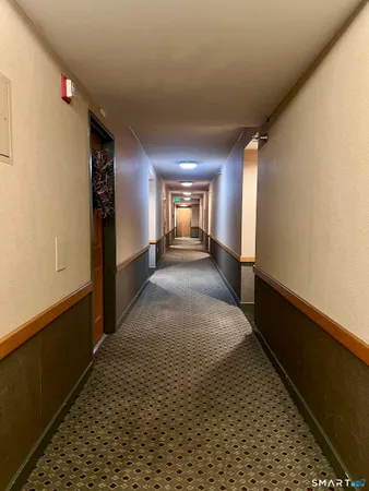 a view of hallway with wooden floor